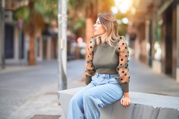 Fototapeta premium Young beautiful woman smiling happy and confident. Standing and walking at town street