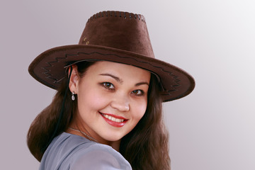 portrait of a young girl in a hat against a plain background, of Asian appearance