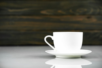 Coffee cup on table with wood background