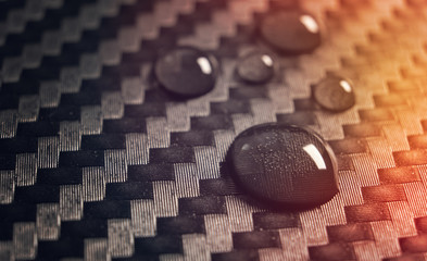 Water drops on carbon fiber fabric surface waterproof background