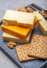 Cheese collection, matured and orange original British cheddar cheese in blocks served with crackers