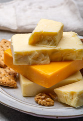Cheese collection, matured and orange original British cheddar cheese in blocks served with crackers
