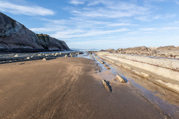 Fototapeta na wymiar View of zumaia beach with its famous rock formations, called flysch, on a sunny day. 