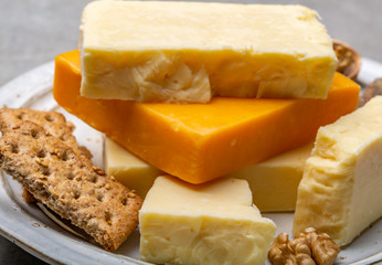 Cheese collection, matured and orange original British cheddar cheese in blocks served with crackers
