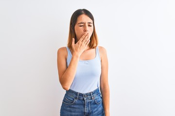 Beautiful redhead woman standing over isolated background bored yawning tired covering mouth with hand. Restless and sleepiness.