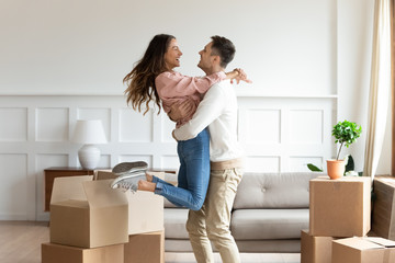 Overjoyed couple dancing excite to move in together - obrazy, fototapety, plakaty