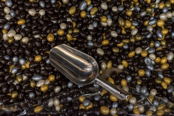 Assorted rainbow sweet icing sugar candies. Top view. Jelly sweets chocolate candies in scoop