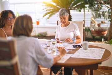 Young beautiful girl smiling happy and confident sitting dinking cup of coffee at terrace