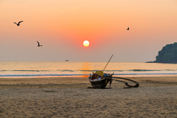 Beautiful beach view landscape with yellow sand and blue ocean in the evening sunset, Goa state in India