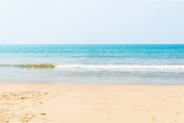 Fototapeta na wymiar Beautiful beach view with fishing boat, yellow sand and blue ocean, Goa state in India
