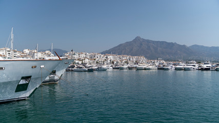 Fototapeta na wymiar marbella marina scape on a sunny day with houses, boats and the sea, spain