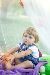 little girl in nature under a canopy