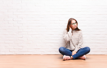 young blonde pretty girl looking serious and curious, listening, trying to hear a secret...