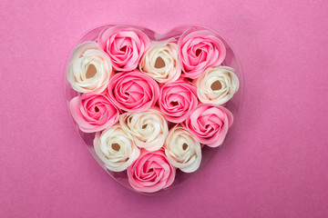 Heart Shaped Pink and white Rose Arrangement on a pink Background. Valentine Day