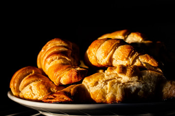 Croissants on a dark background. A delicious mouth-watering breakfast.