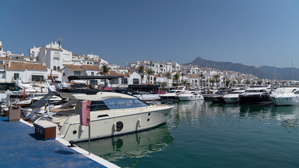 marbella marina cityscape on a sunny day with houses, boats and the sea, spain