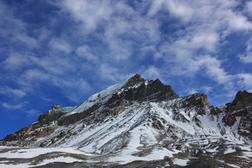 Snowy mountains against the blue sky with white clouds. Mountains of Nepal