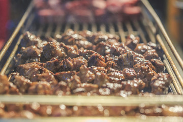 Beef Steak Dice Cooking. Grilled beef on charcoal stove. Diced Beef Steak Japanese Style. Saikoro Steak. Asian street food night market. Regional Food