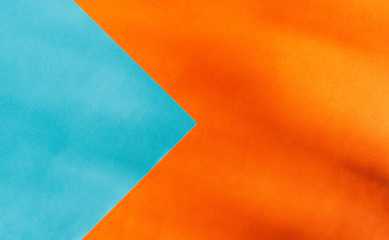 Background of two papers in contrasting colors of blue and orange with copy space