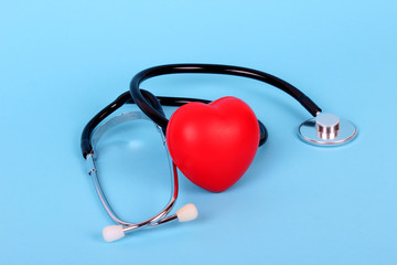 stethoscope and heart isolated on blue background