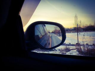 Car mirror at dawn in the winter.