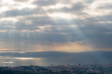 Sunset lights under Spanish town. Sea. Andalusia 