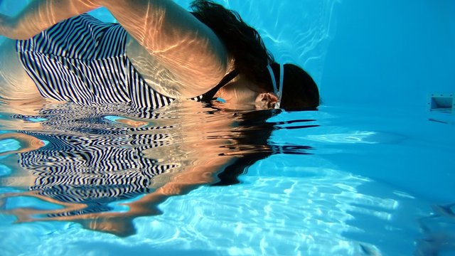Side View Of Woman Swimming In Water