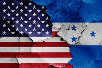 flags of USA and Honduras painted on cracked wall