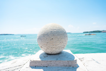 Stone Bridge Balls. Stone balls on bridge parapet on blue Lagoon in Venice, Italy. Architecture detail. Stone Balustrade with decoration balls. Old Authentic Bridge Staircase made of White Granite. 