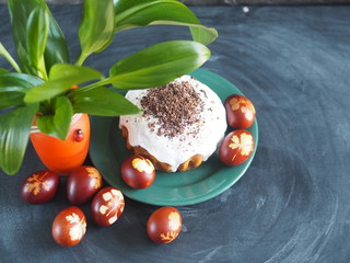 Easter. Traditional Easter cakes with painted eggs in an onion peel and a green bouquet of fresh leaves. We celebrate the holiday.