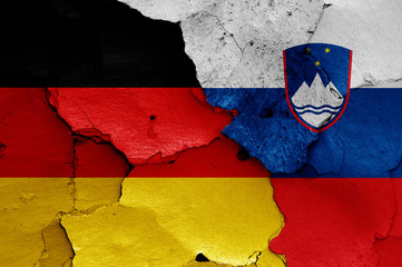 flags of Germany and Slovenia painted on cracked wall