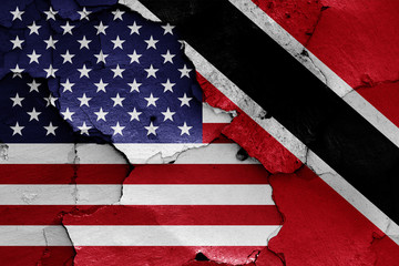flags of USA and Trinidad and Tobago painted on cracked wall