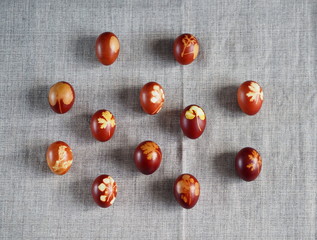 Easter. Traditional onion-peeled eggs on a canvas tablecloth. Arranged in synchronous order. We celebrate the holiday.