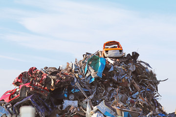 Crane picking up a car in a junkyard