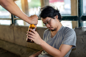 Portrait hand handed liquor to a drunken man and he took it.