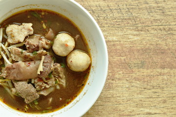 braised pork and ball with bean sprout in brown soup on bowl