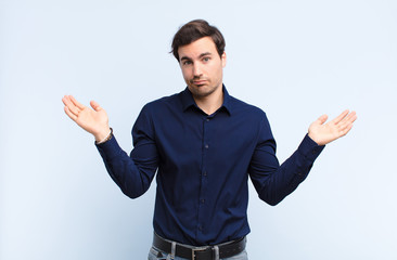 young handsome man feeling puzzled and confused, doubting, weighting or choosing different options...