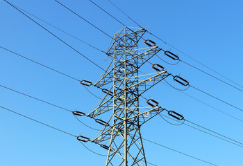 Electrical network of high voltage. Transportation of electricity through the high-voltage line. Metal tower with wires and cables. Clean country energy. Energy security. Work at height. Training matt