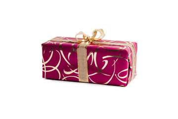packaged rectangular gift in dark pink packaging with gold bow and gold pattern on the white background