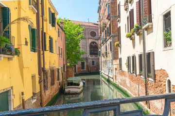 Fototapeta na wymiar Venice. Venetian Canals. Colorful Old Authentic Buildings Palazzo in Venice. Amazing architecture of ancient Italian city. Travel in Europe. Landmark Travel Tourism Concept. 