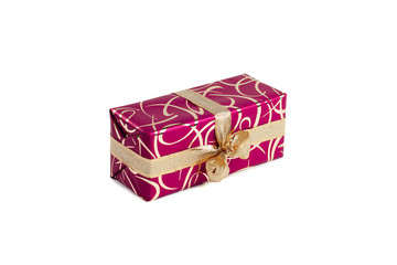 packaged rectangular gift in dark pink packaging with gold bow and gold pattern on the white background