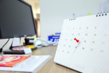 Red color pin on the calendar Event Planner is busy, planning for business meeting or travel planning.