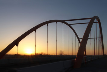 Fototapeta premium Rzeszow, Poland - 9 9 2018: Suspended road bridge across the autobahn. Metal construction technological structure. Modern architecture