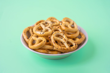 Salted pretzel in white saucer, stock photo