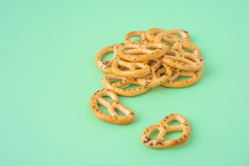 Pile of pretzels on green background, stock photo.