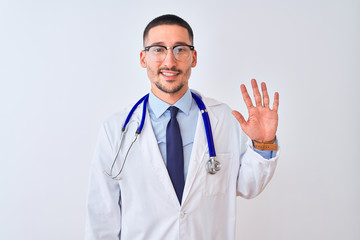 Fototapeta premium Young doctor man wearing stethoscope over isolated background showing and pointing up with fingers number five while smiling confident and happy.