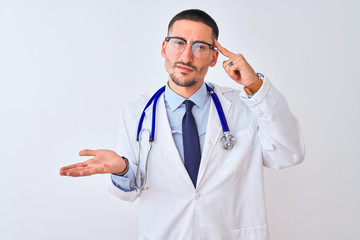 Young doctor man wearing stethoscope over isolated background confused and annoyed with open palm...