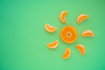 Fresh ripe tangerine pieces in sun shape