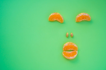 Tangerine slices as a funny muzzle, stock photo