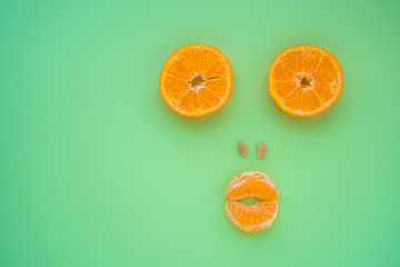 Tangerine slices as a funny muzzle, stock photo